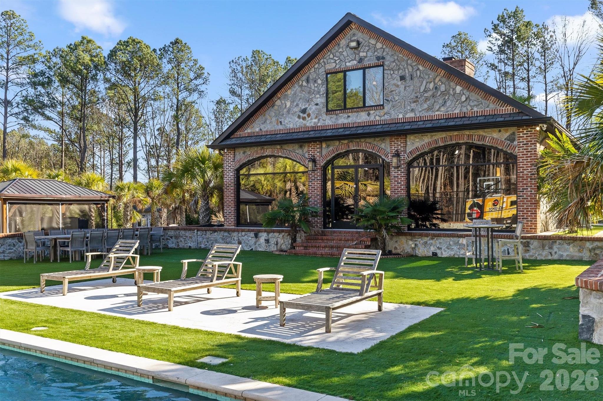 135 Stillwater Road Troutman, NC 28166 - Photo 25 of 43 a view of a swimming pool with outdoor seating and a yard