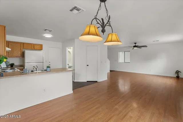a view of a room with wooden floor and window