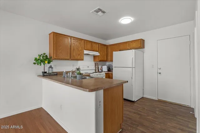 a kitchen with a sink and refrigerator