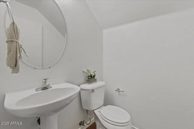 a bathroom with a sink toilet and a mirror