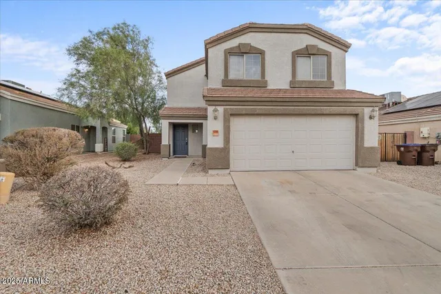 a view of a house with a yard and garage