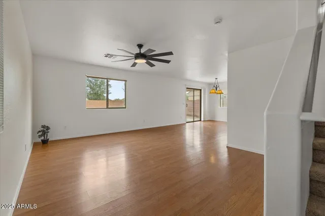 a view of room with hardwood floor and ceiling fan