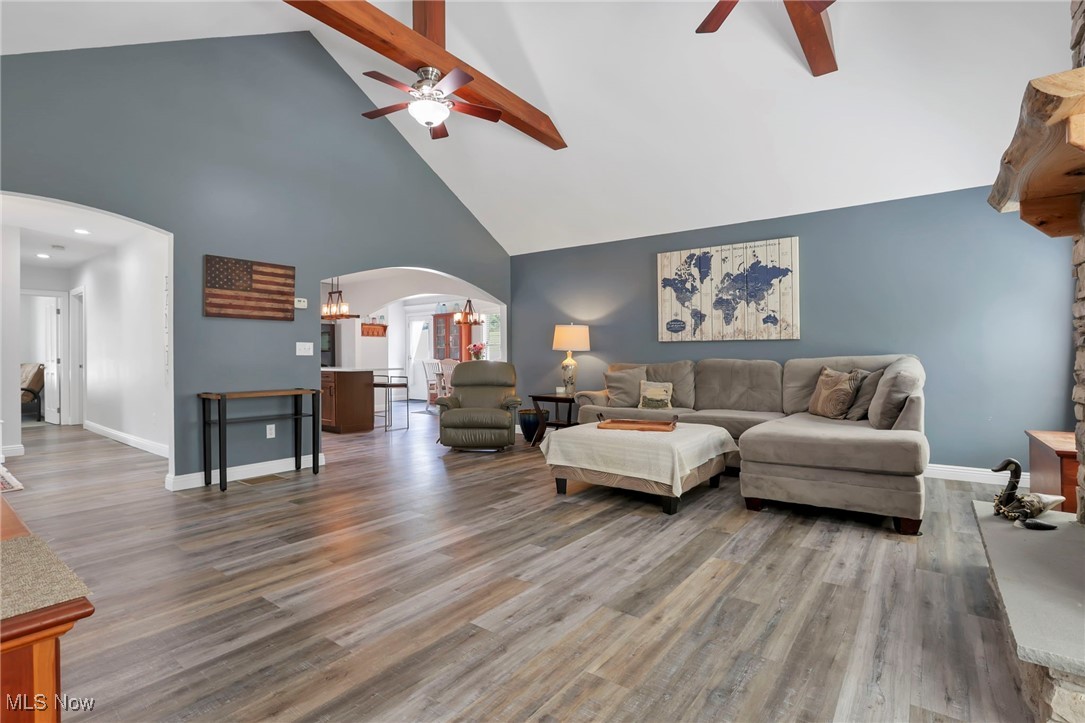 1890 Baltimore Road Northwest Lancaster, OH 43130 - Photo 18 of 50 Living room featuring high vaulted ceiling, ceiling fan with notable chandelier, hardwood / wood-style flooring, and beam ceiling