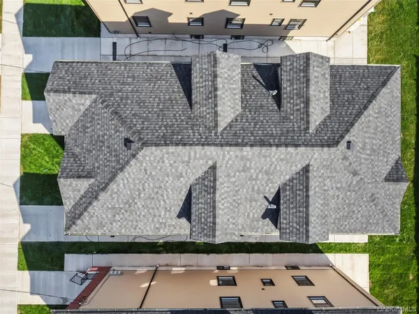 an aerial view of a house with parking space