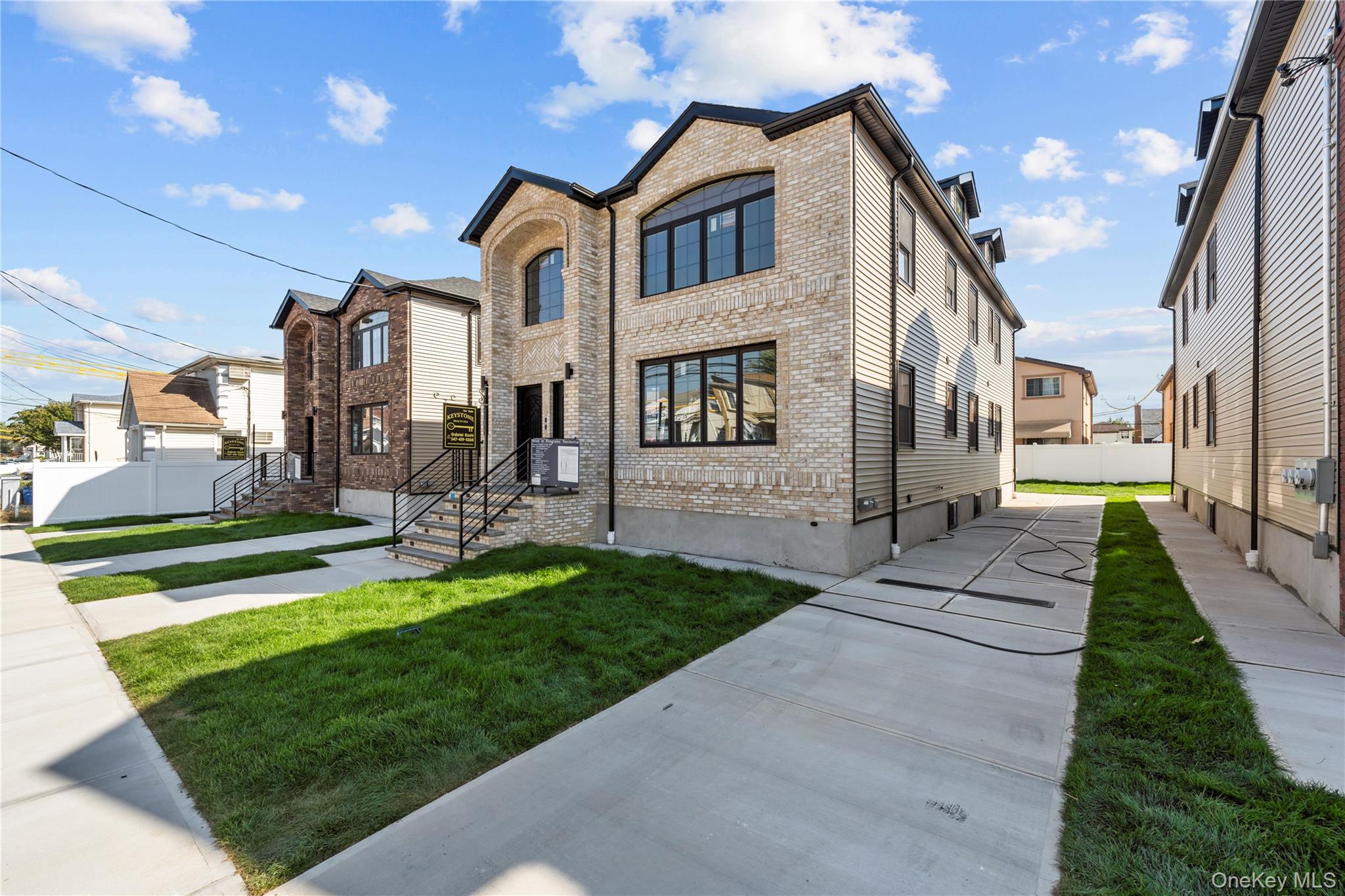 258-14 147th Road Queens, NY 11422 - Photo 16 of 17 a front view of a house with a yard