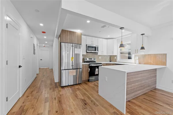 a kitchen with a refrigerator a sink and cabinets
