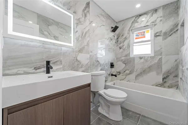 a bathroom with a sink a toilet and a bathtub