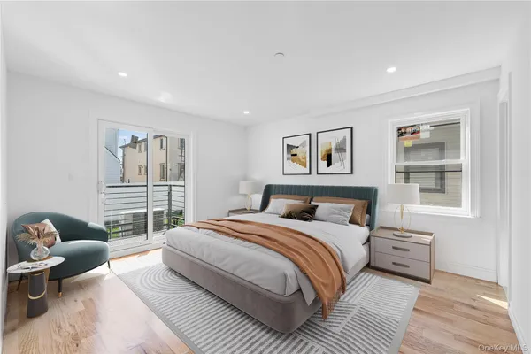 a bedroom with a large bed couch and a window