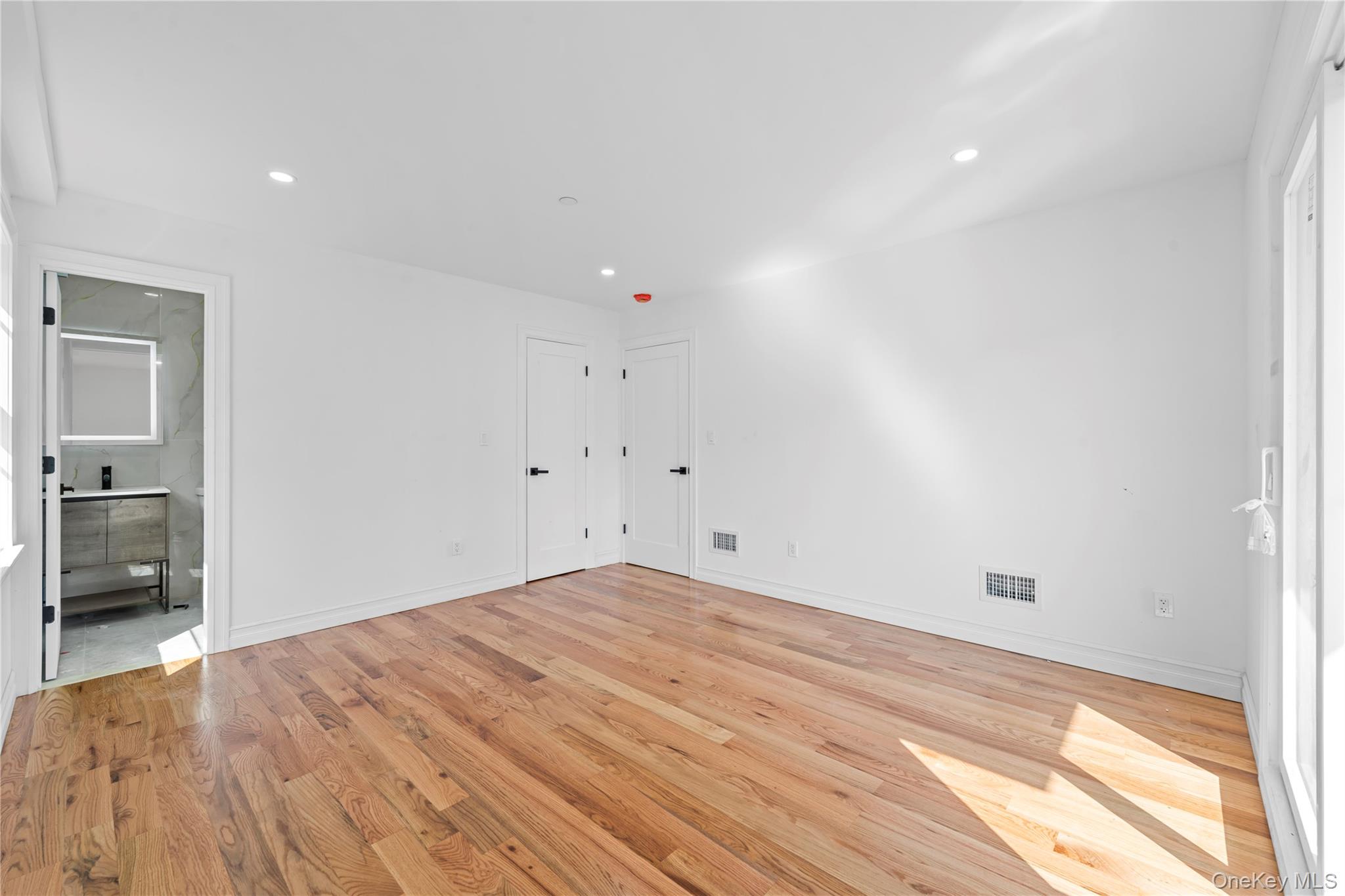 258-14 147th Road Queens, NY 11422 - Photo 7 of 17 a view of empty room with wooden floor