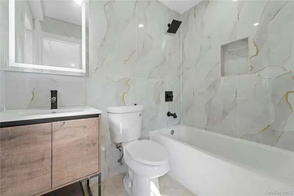 a bathroom with a toilet sink and bathtub