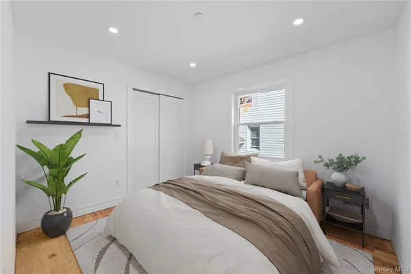 a bedroom with a bed and a potted plant