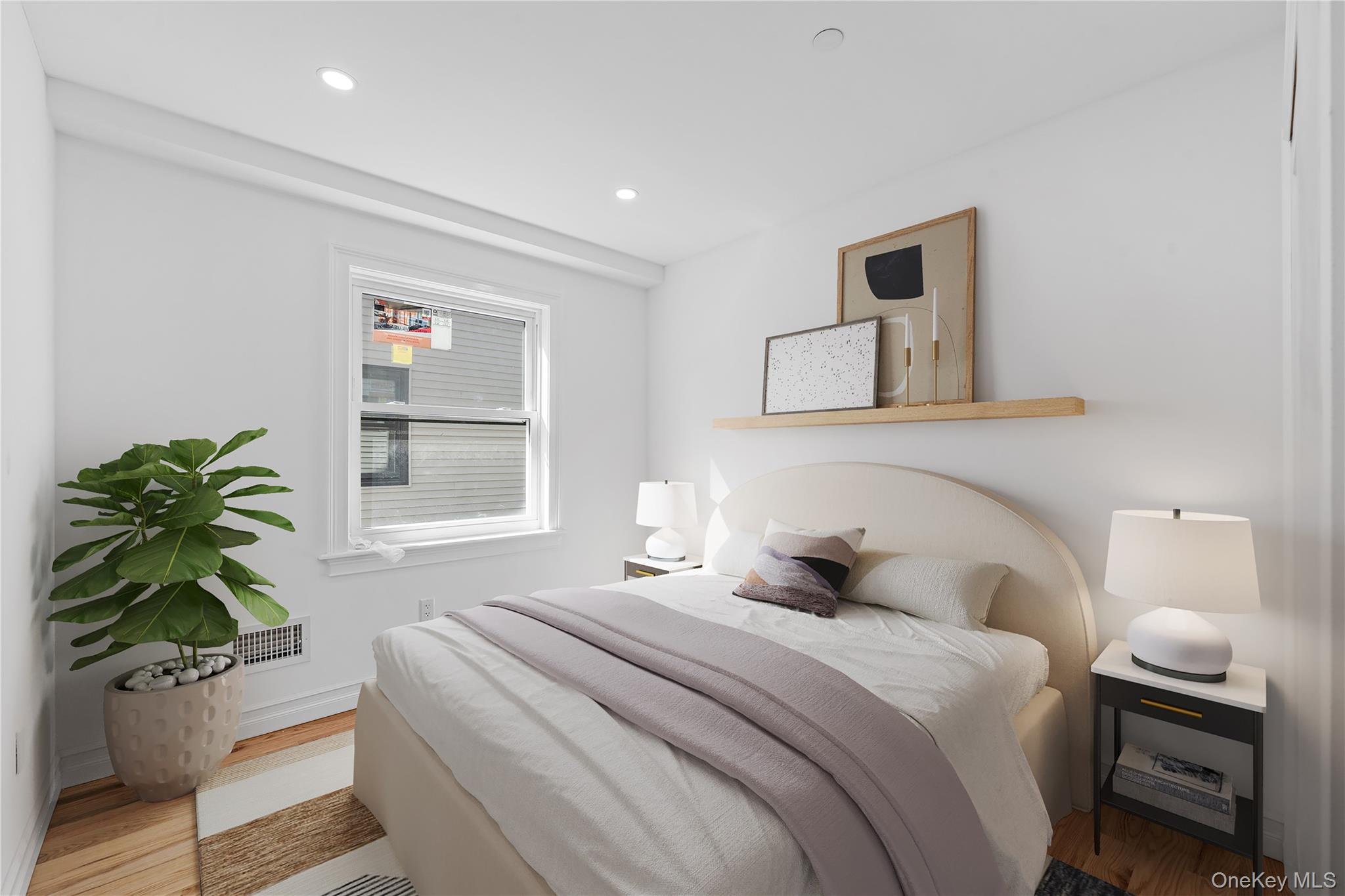 258-14 147th Road Queens, NY 11422 - Photo 10 of 17 a bedroom with a bed and a potted plant