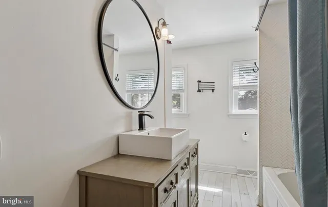 a bathroom with a sink and a mirror