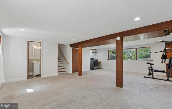 a view of a livingroom with furniture and floor to ceiling window