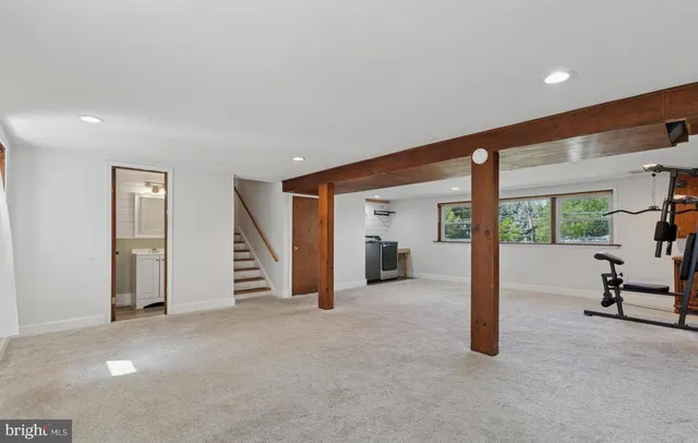a view of a livingroom with furniture and floor to ceiling window