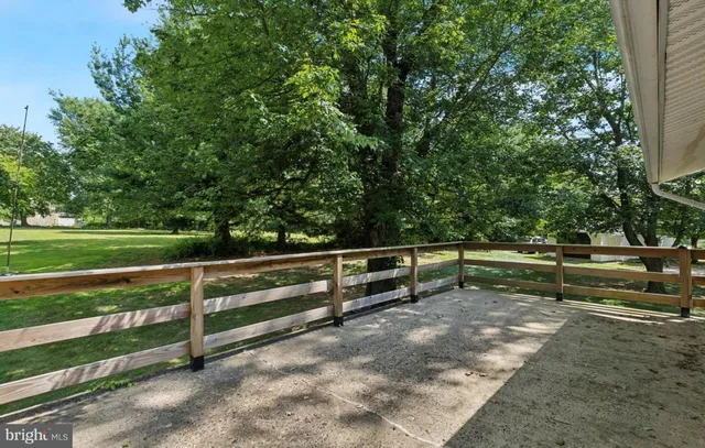 a view of a yard with wooden fence