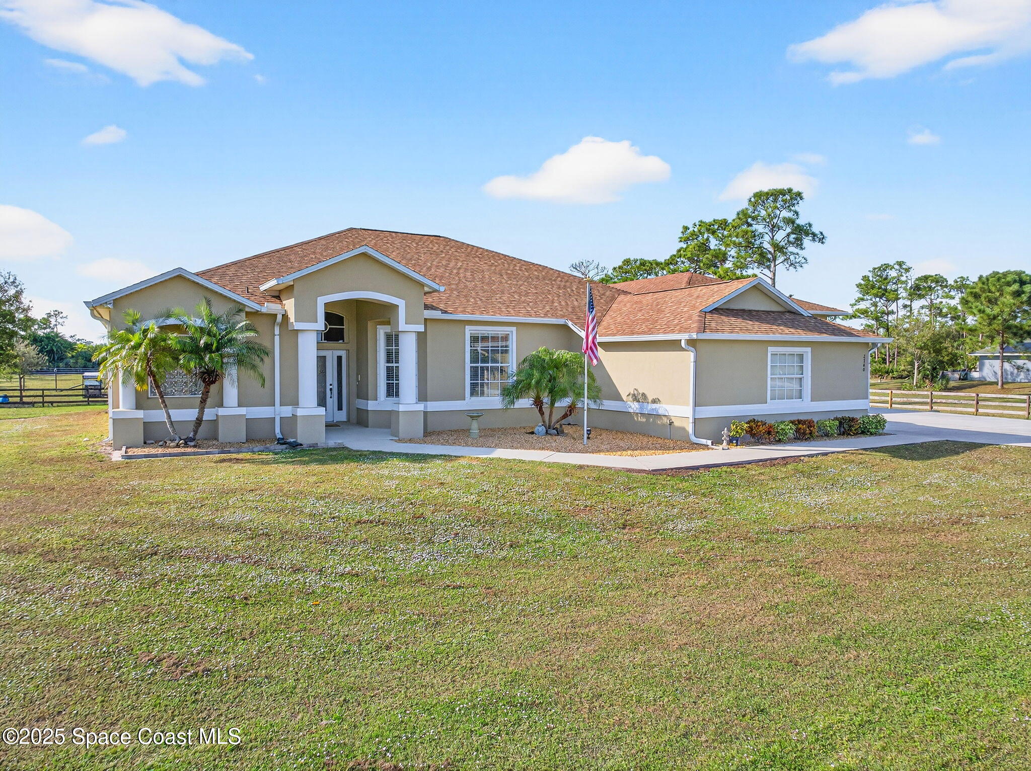 2740 Waring Lane Malabar, FL 32950 - Photo 1 of 98 a front view of a house with a garden