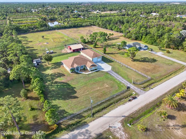 an aerial view of a house with yard swimming pool and outdoor seating