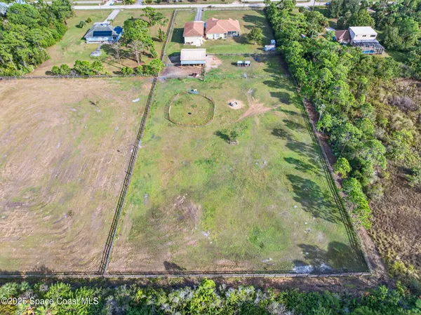 an aerial view of a house with a lake view
