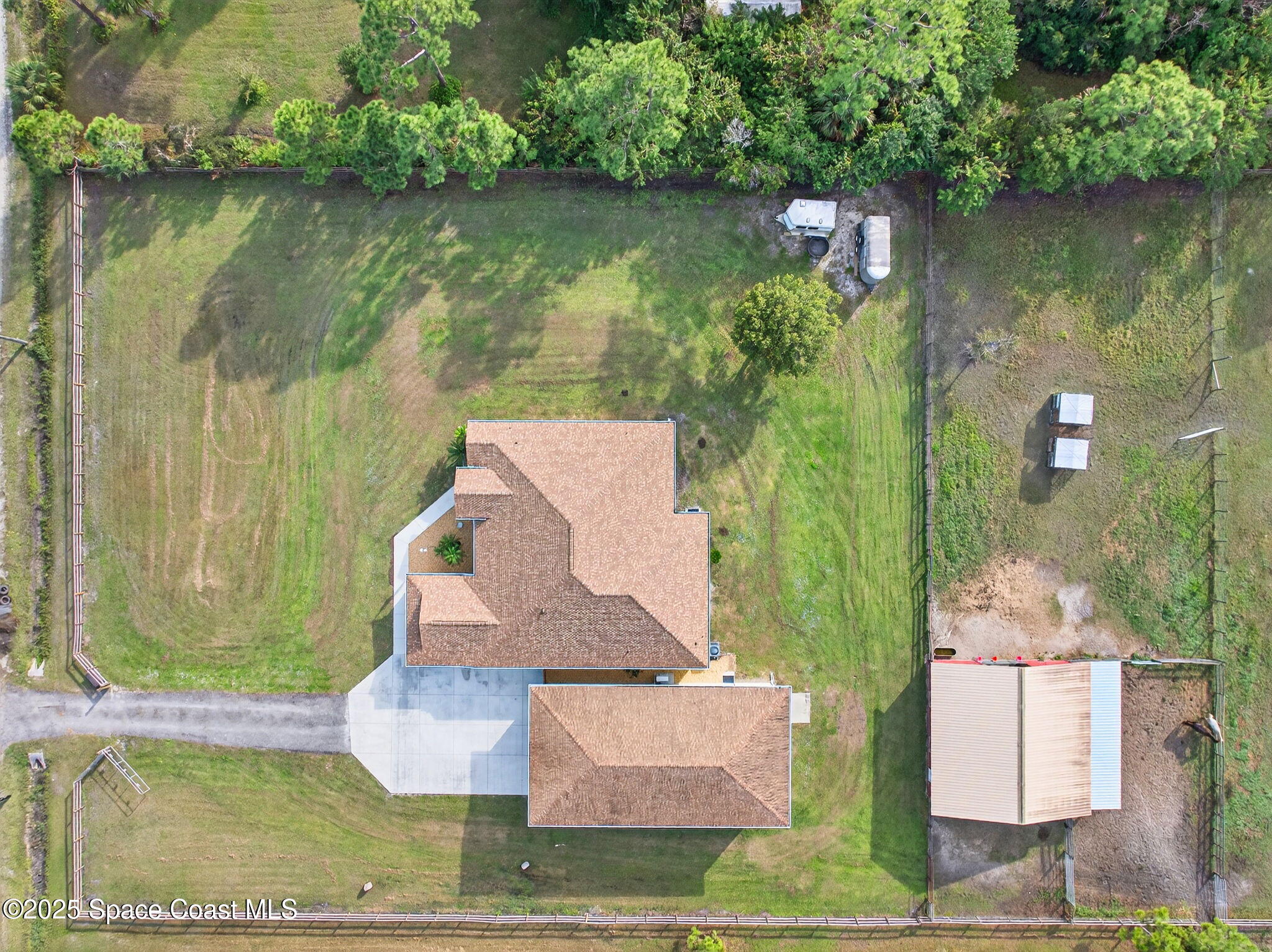 2740 Waring Lane Malabar, FL 32950 - Photo 34 of 98 an aerial view of a house with a yard lake swimming pool and outdoor seating