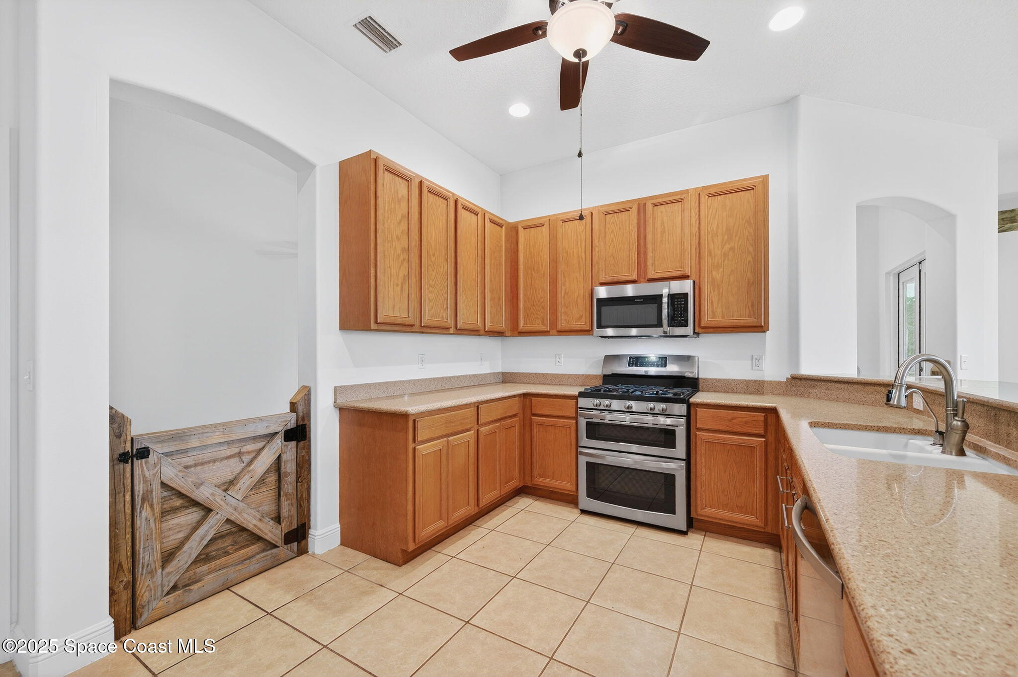 2740 Waring Lane Malabar, FL 32950 - Photo 60 of 98 a kitchen with stainless steel appliances granite countertop a stove and a sink