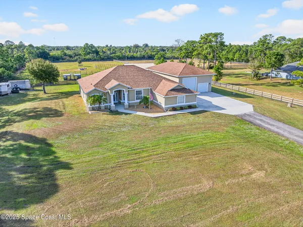 a aerial view of a house with pool lake view and mountain view