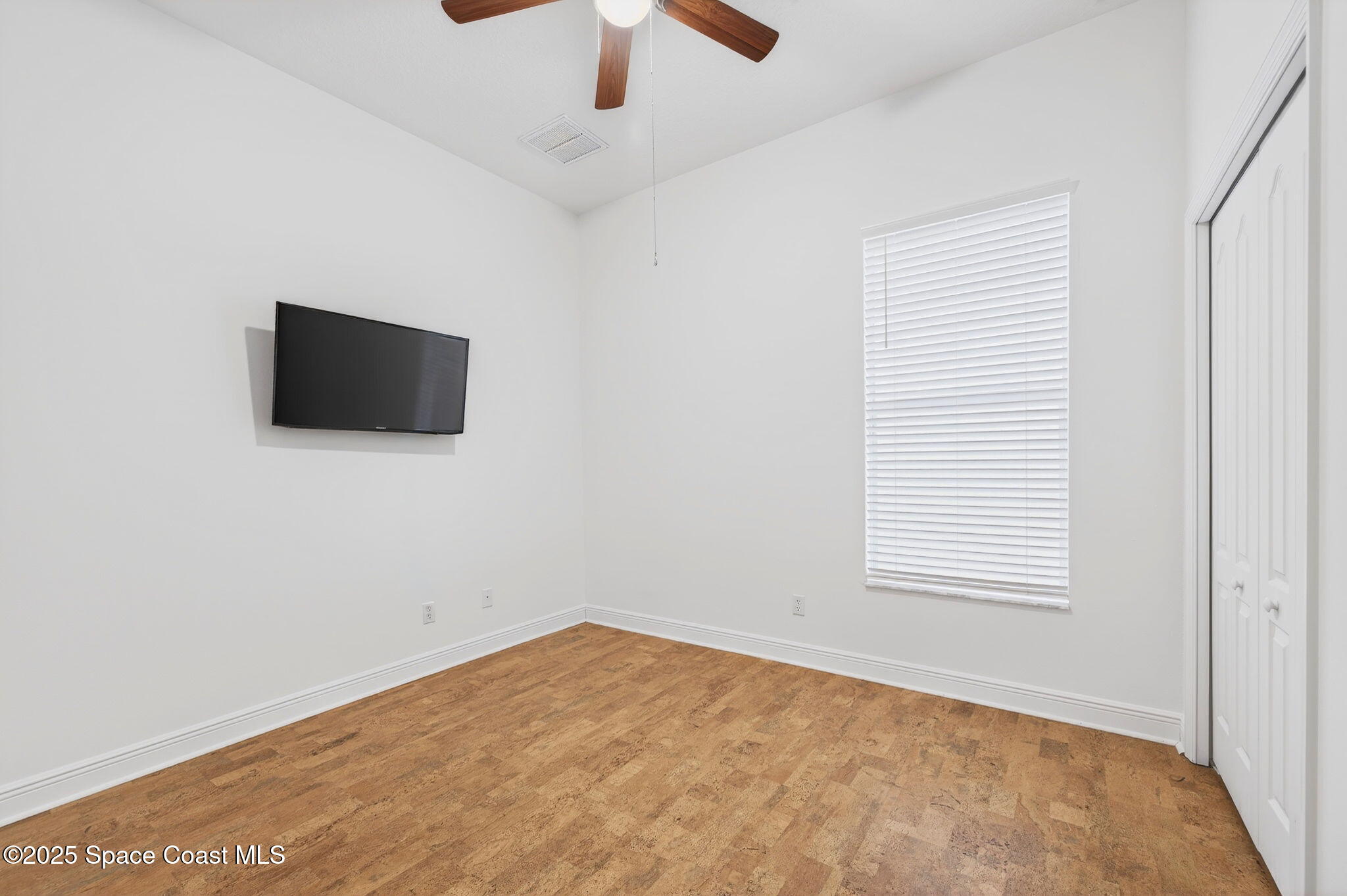 2740 Waring Lane Malabar, FL 32950 - Photo 73 of 98 en empty room with ceiling fan and window