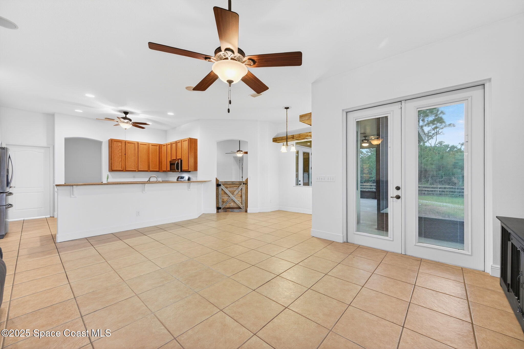 2740 Waring Lane Malabar, FL 32950 - Photo 79 of 98 a view of a livingroom with a chandelier fan and windows