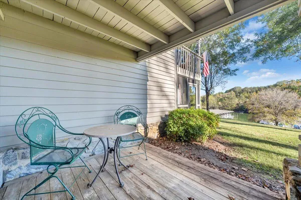 a backyard of a house with outdoor seating and trees