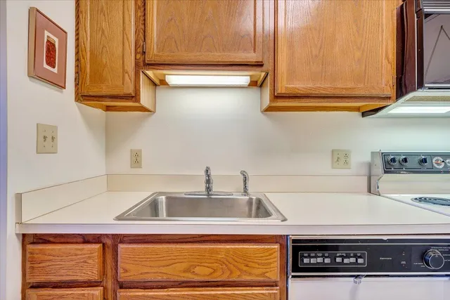 a kitchen with stainless steel appliances granite countertop a sink and cabinets
