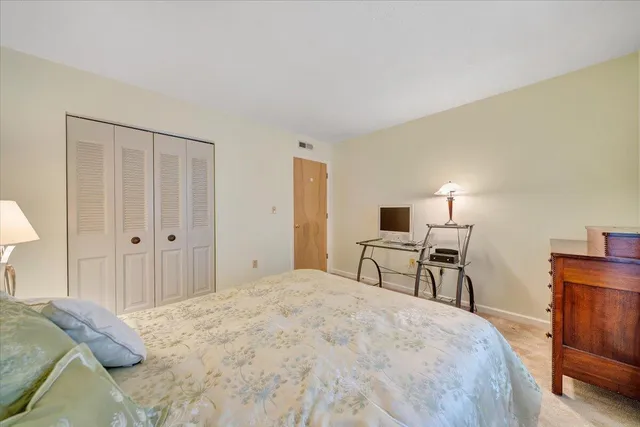 a bedroom with a bed and a desk