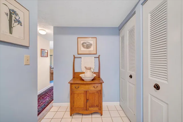 a room with painting on the wall and a potted plant