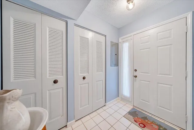a view of a bedroom with a bed and a window