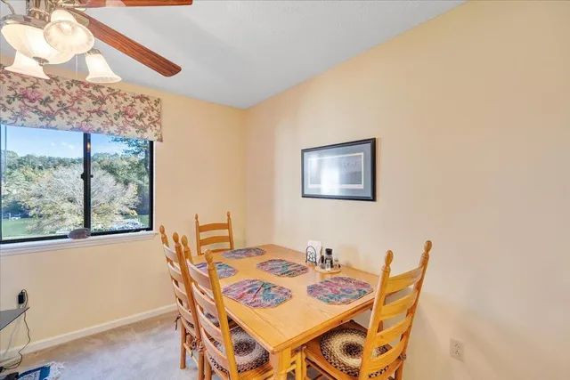 a dining room with furniture and window