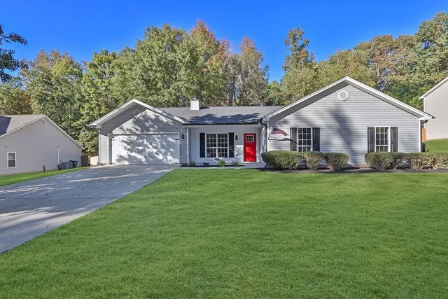 a front view of a house with a garden