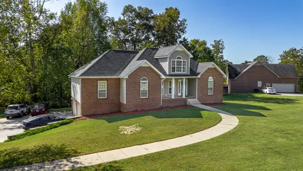 a front view of a house with a yard