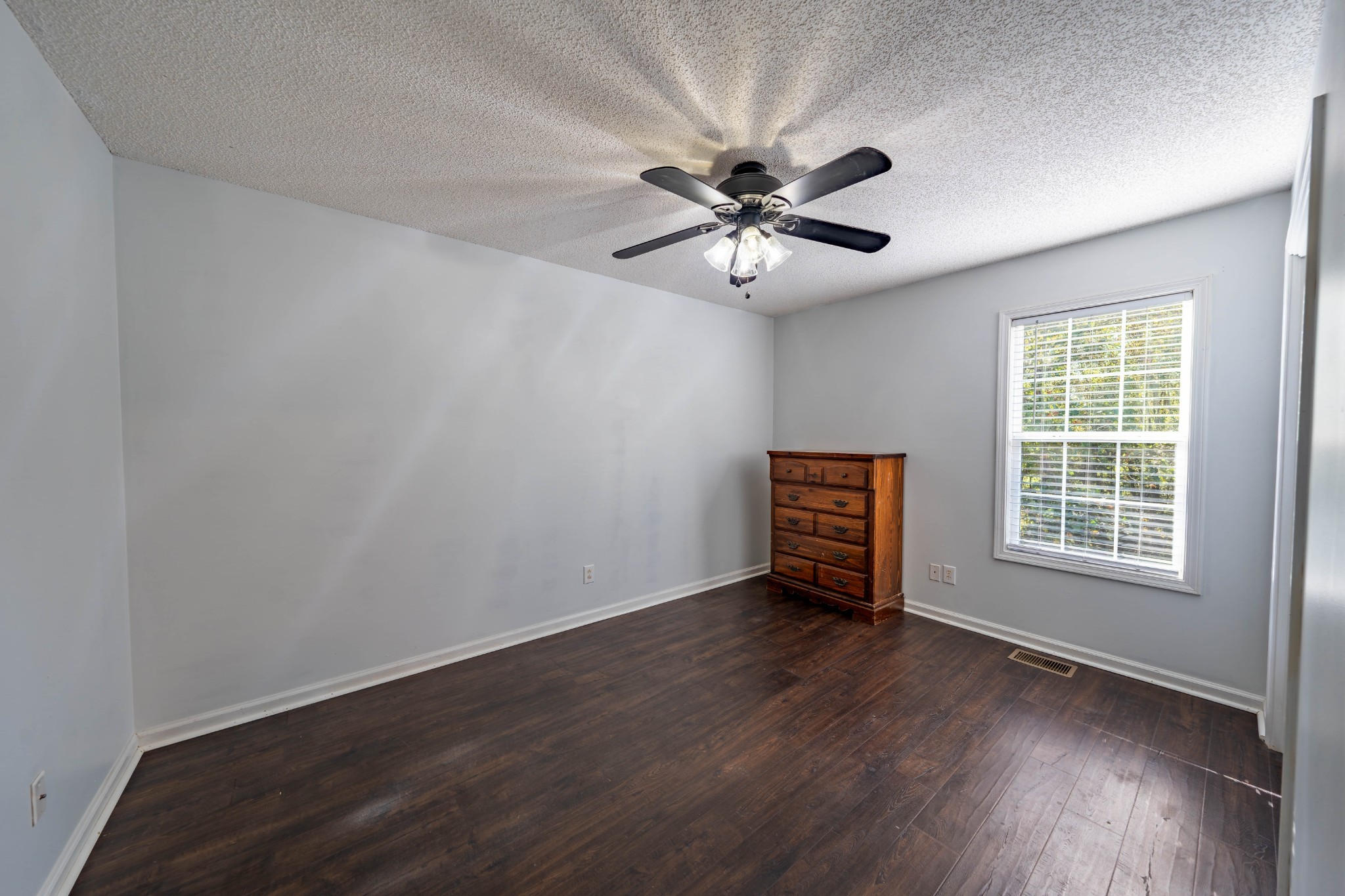 1101 Rustling Oaks Drive Pleasant View, TN 37146 - Photo 18 of 19 a view of an empty room with a window and wooden floor