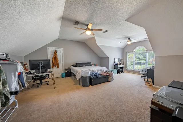 a living room with furniture a fireplace and a large window