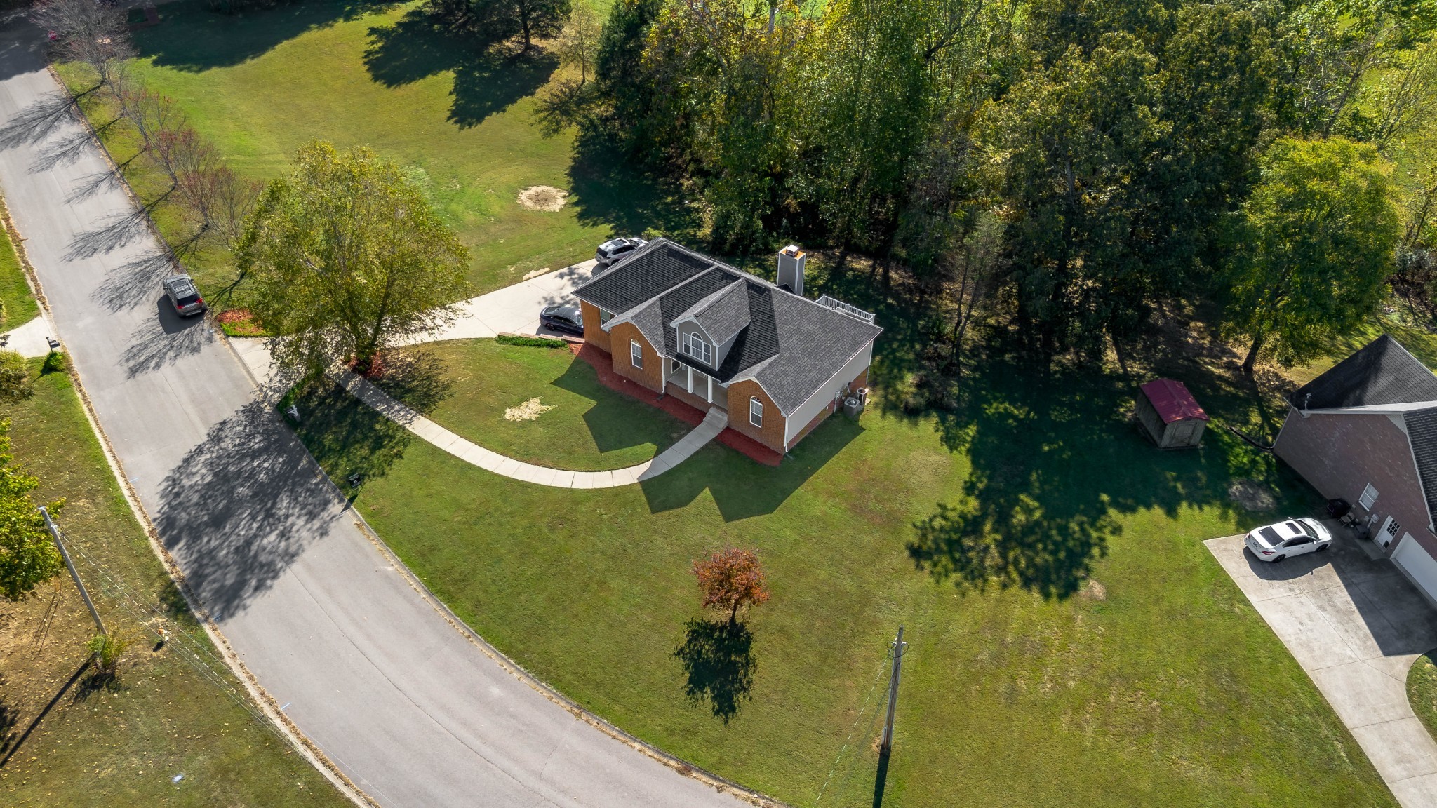 1101 Rustling Oaks Drive Pleasant View, TN 37146 - Photo 2 of 19 an aerial view of a house with a garden and trees