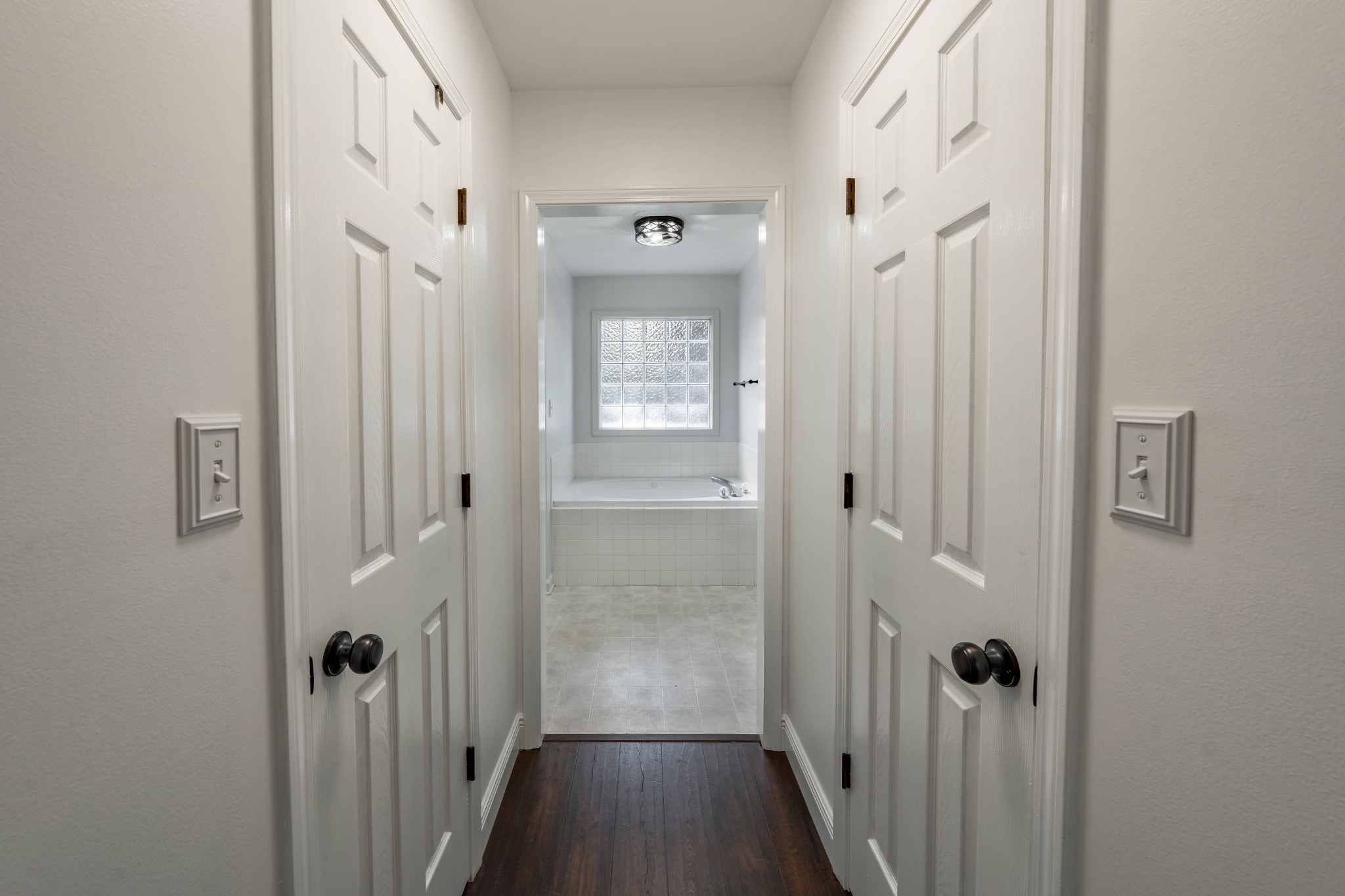 1101 Rustling Oaks Drive Pleasant View, TN 37146 - Photo 8 of 19 a view of a hallway with a wooden floor and a bathroom