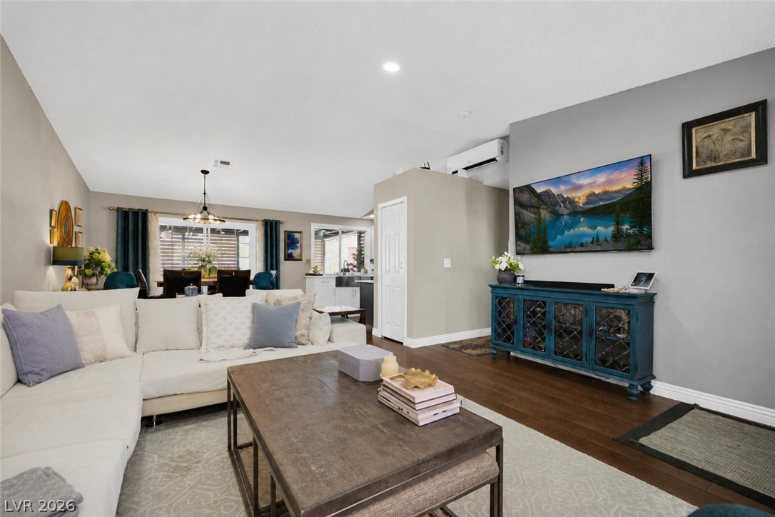 530 Grape Drive Henderson, NV 89015 - Photo 5 of 39 An inviting great room with rich hardwood flooring extends to a dining area with elegant lighting.