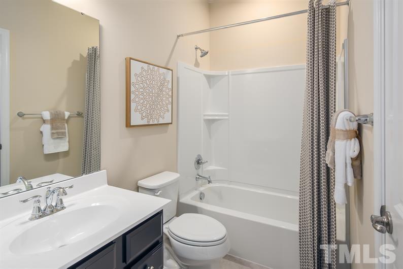 6607 Pathfinder Way Raleigh, NC 27616 - Photo 4 of 6 a bathroom with a sink toilet and shower