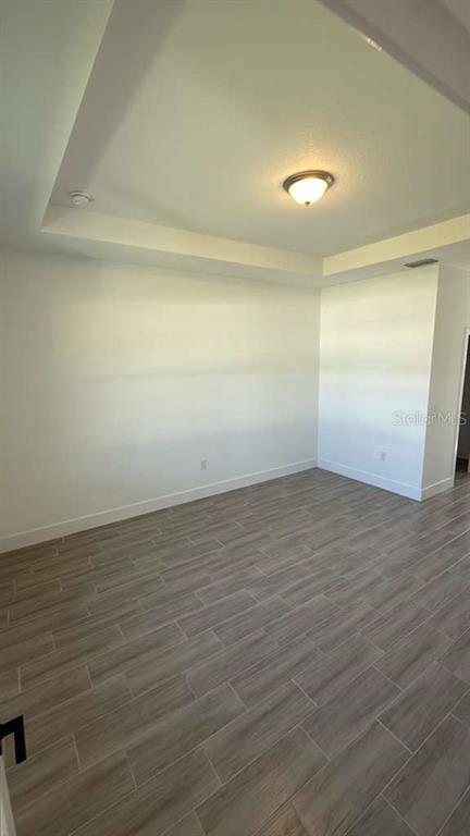 2827 Southwest 137th Lane Ocala, FL 34473 - Photo 6 of 11 an empty room with wooden floor and windows