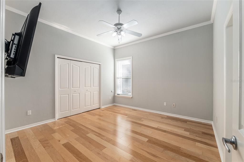 10614 Southwest 15th Lane Gainesville, FL 32607 - Photo 57 of 85 a view of a room with a ceiling fan and a hardwood floor