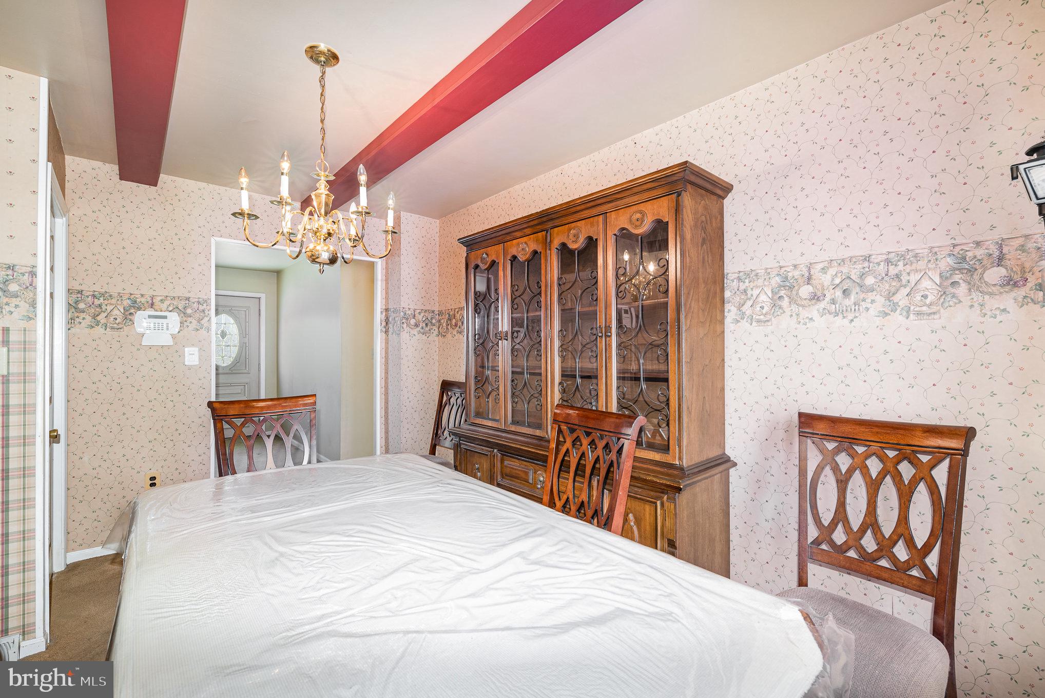 517 Joppa Farm Road Joppa, MD 21085 - Photo 8 of 25 a bedroom with a bed and a chandelier