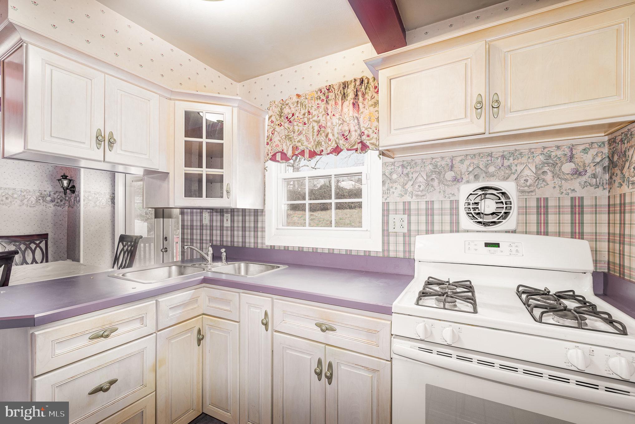 517 Joppa Farm Road Joppa, MD 21085 - Photo 10 of 25 a kitchen with white cabinets and appliances