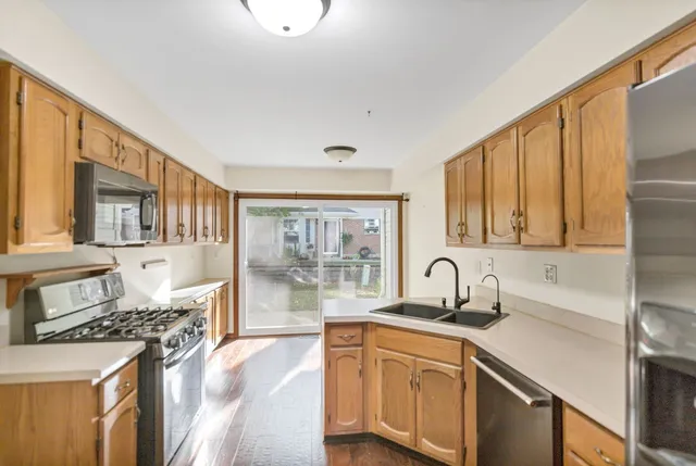a kitchen with stainless steel appliances granite countertop a sink stove and cabinets