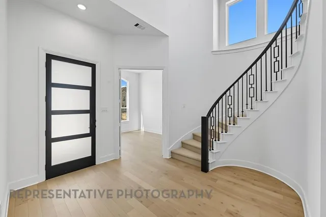 a view of staircase with white walls and windows