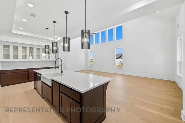 a kitchen with stainless steel appliances granite countertop a stove a sink and a white cabinets