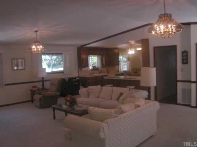 206 Dartmouth Road Raleigh, NC 27609 - Photo 5 of 9 a living room with furniture and a chandelier
